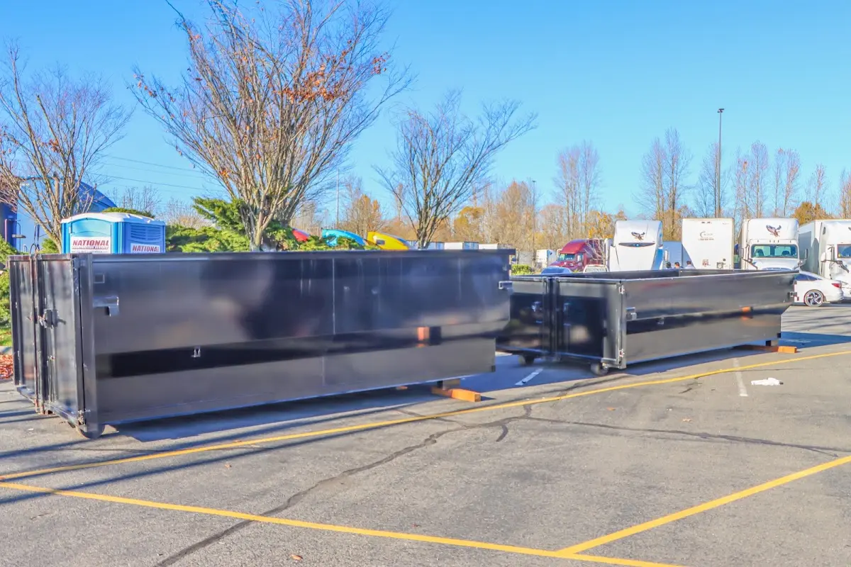 Professional dumpster rental service with roll-off container on residential driveway in Prosper